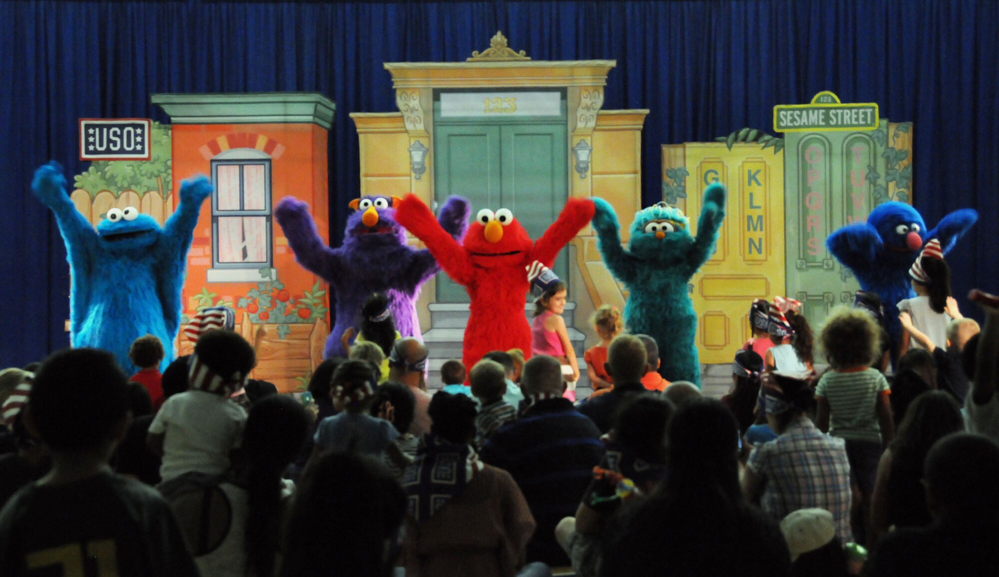 Characters from Sesame Street perform for military families during the Sesame Street United Service Organizations Experience for Military Families tour Nov. 2, 2013, on Andersen Air Force Base, Guam. The tour has performed approximately 433 shows on 131 military bases in 33 states and 11 countries, since July 2008. (U.S. Air Force photo by Airman 1st Class Amanda Morris/Released)