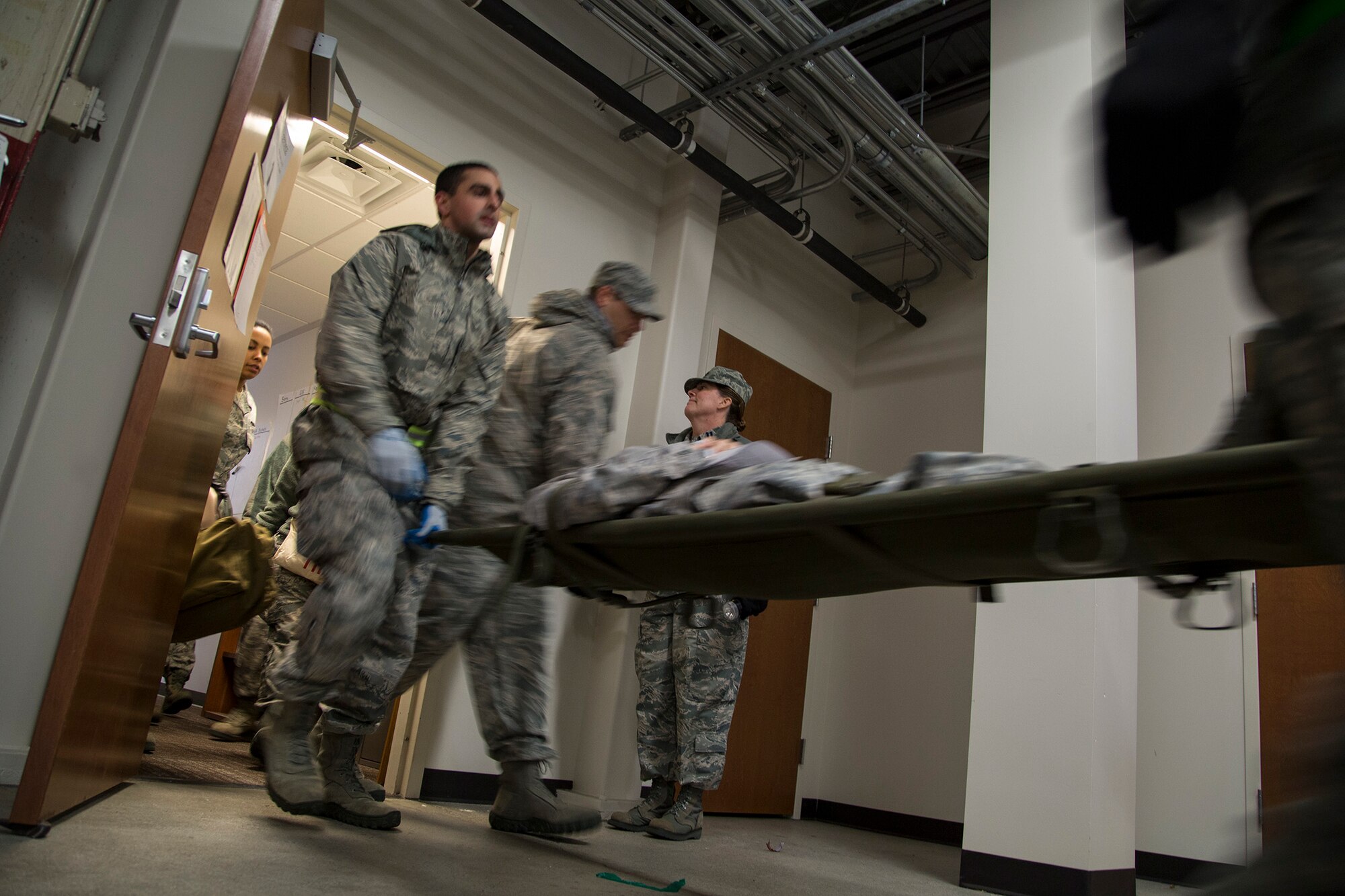 Reserve Airmen from the 446th Aeromedical Staging Squadron move with reckless abandon as they carry a "patient" to a triage area during the Reserve drill weekend, Nov. 2. About 130 Reserve Airmen from the 446th Aeromedical Staging Squadron at Joint Base Lewis-McChord, Wash. took part in two mass-casualty training exercises in order to remain in compliance with their readiness requirements. (U.S. Air Force Reserve photo by Master Sgt. Jake Chappelle)