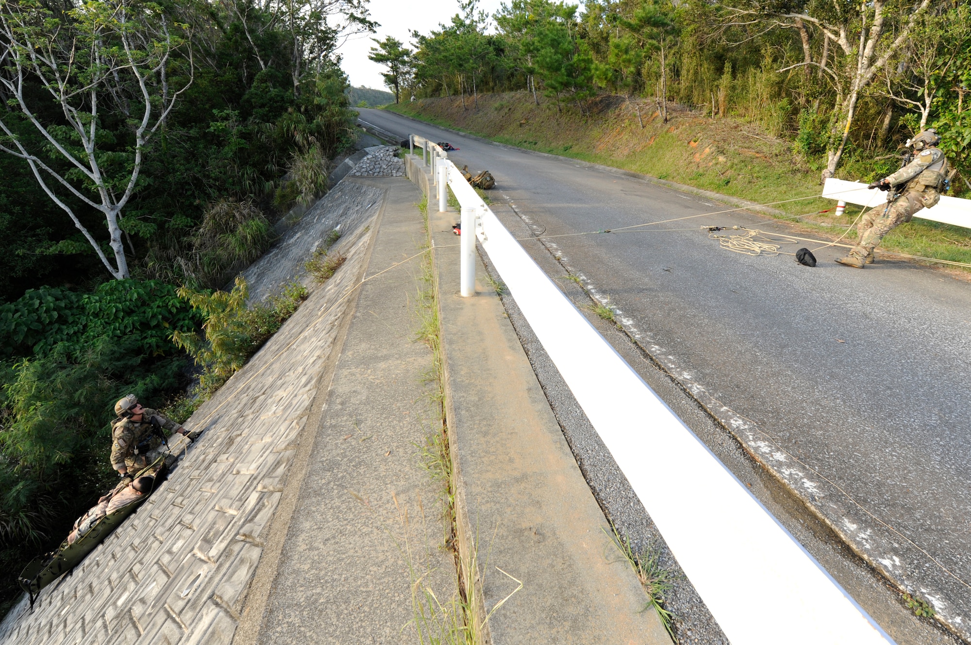 U.S. Air Force Airmen from the 31st Rescue Squadron haul up a simulated casualty during a war week exercise at Marine Corps Camp Hansen's training area, Japan, Oct. 29, 2013. While moulage makes injuries look more realistic and helps train Airmen, volunteers properly acting out their role allows pararescuemen to adequately assess scenarios and treat injuries. (U.S. Air Force photo by Senior Airman Marcus Morris)   