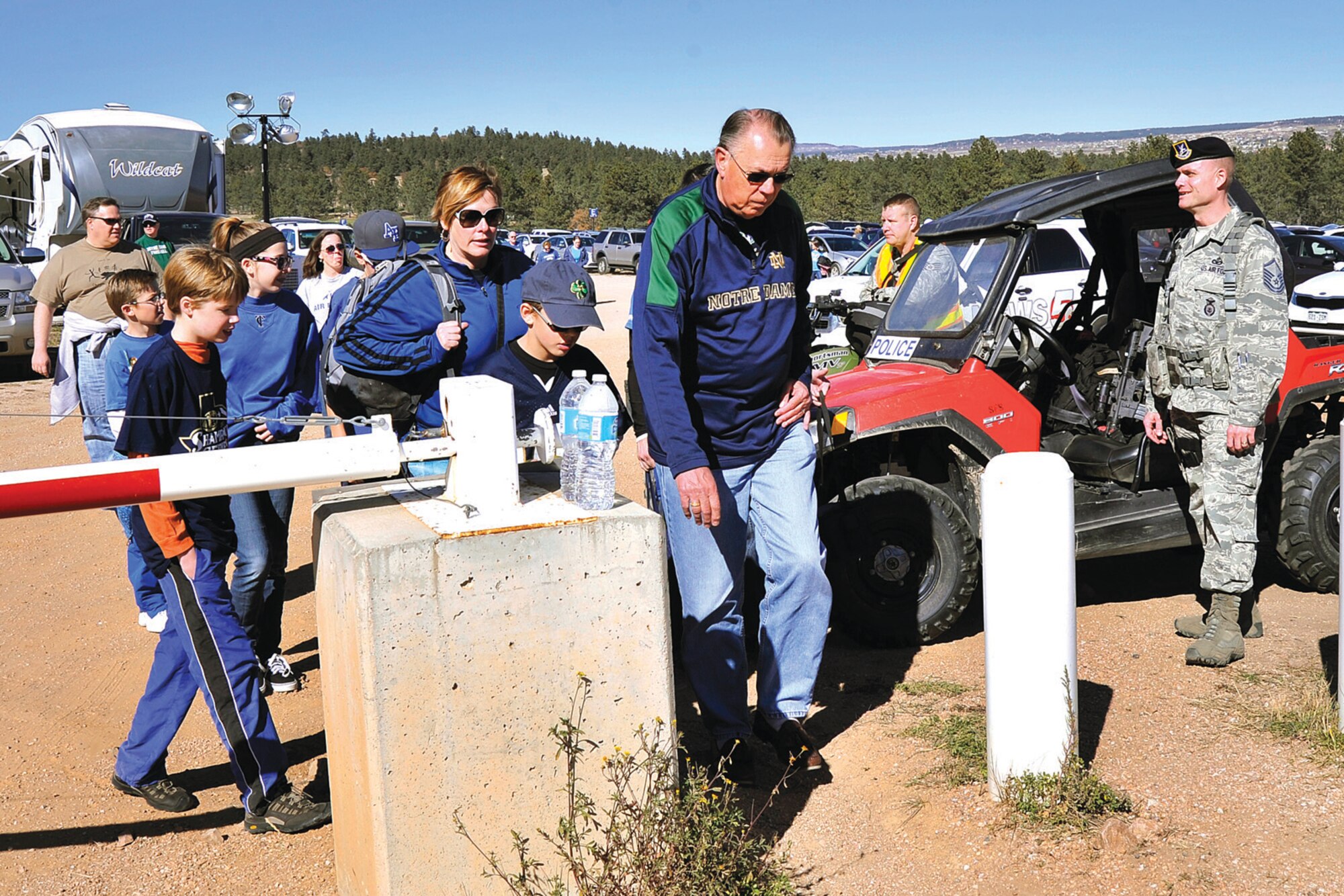 A 10th Security Forces Squadron master sergeant stands ready to assist the thousands of fans trekking toward Falcon Stadium for the Air Force vs. Notre Dame football game at Falcon Stadium here Oct. 26