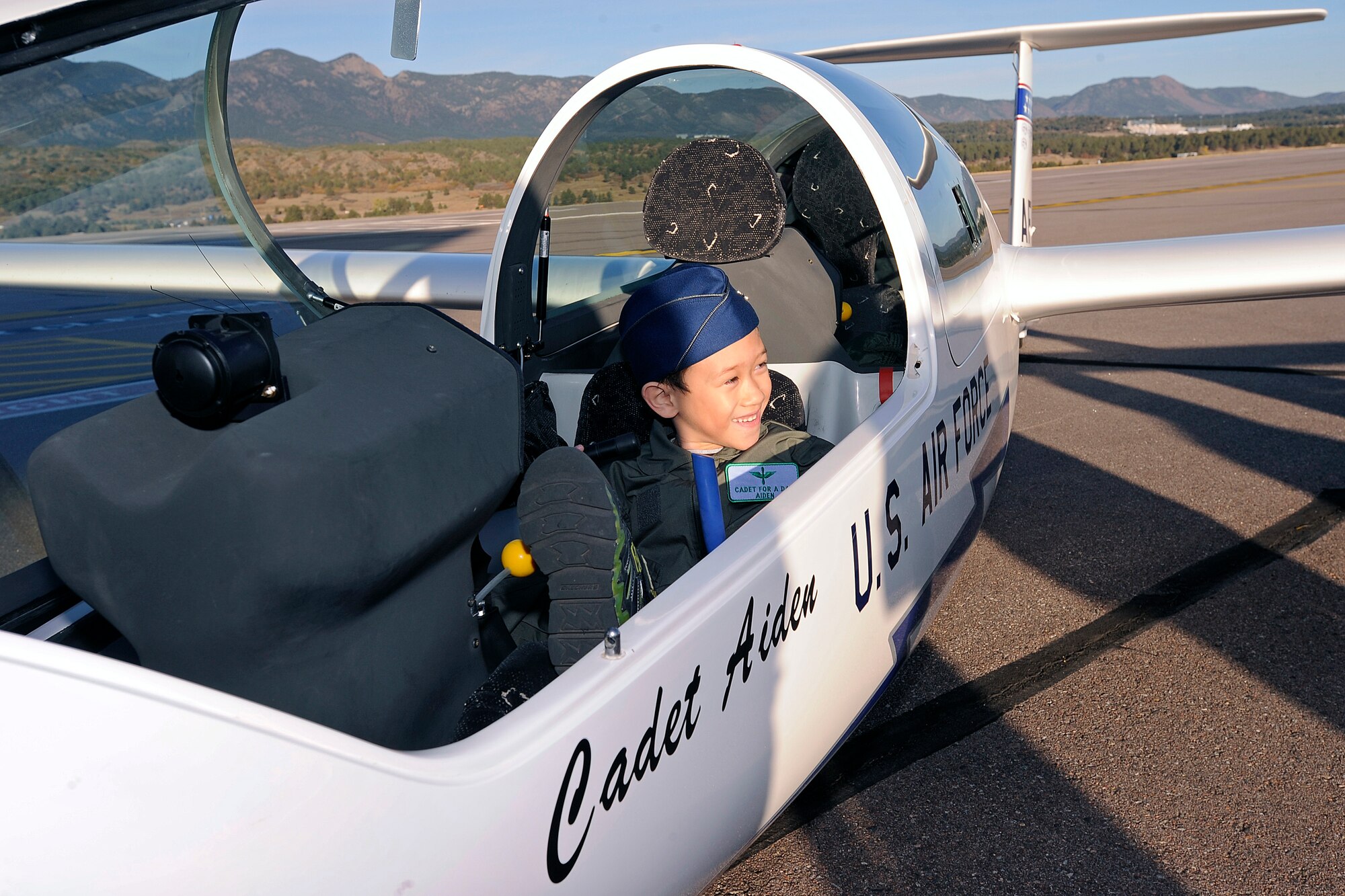 Aidan Peters, the Academy's latest Cadet for a Day, sit behind the controls of a TG-16A Glider on the Academy Airfield Oct. 25. 