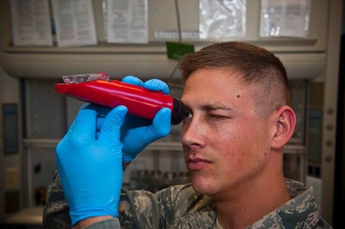 Senior Airman Robbie Bonnette, 99th Logistics Readiness Squadron fuel lab technician, zeroes out a refractometer in the fuels management building Nov. 1, 2013, at Nellis Air Force Base, Nev. The refractometer is used to measure fuel system icing inhibitor content in jet fuel and to make sure the scale is correct when calibrating. (U.S. Air Force photo/Senior Airman Brett Clashman)