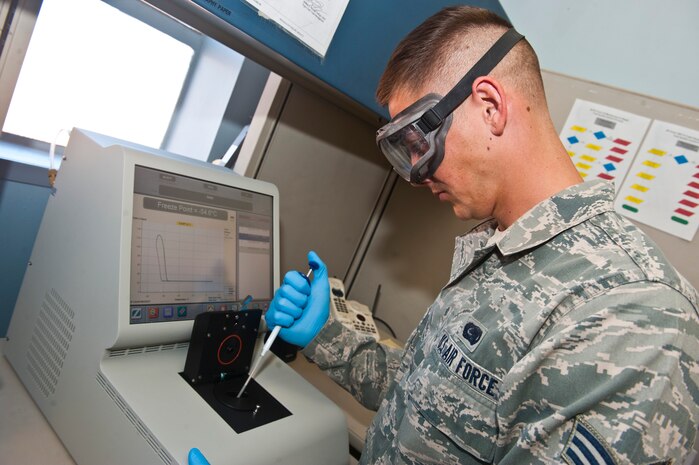 Senior Airman Robbie Bonnette, 99th Logistics Readiness Squadron fuel lab technician, tests a fuel sample through a freeze point analyzer in the fuels management building Nov. 1, 2013, at Nellis Air Force Base, Nev. A freeze point analyzer measures the freezing point of petroleum products. (U.S. Air Force photo/Senior Airman Brett Clashman)