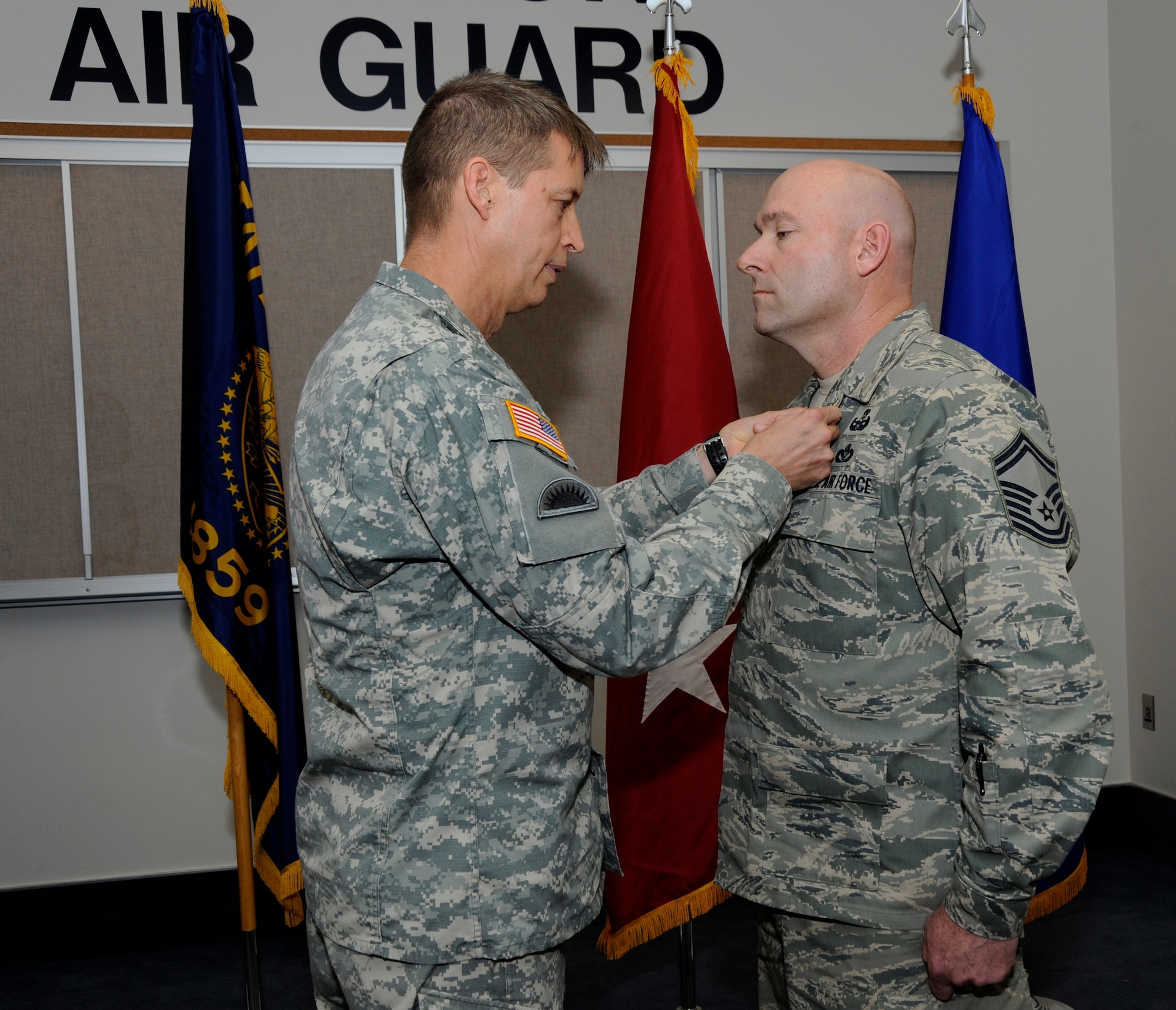 Maj. Gen. Daniel Hokanson, Adjutant General Oregon, awards the Bronze Star Medal to Senior Master Sgt. Brian Wade, of the 142nd Fighter Wing Explosive Ordinance Disposal unit, during a ceremony held at the Portland Air National Guard Base, in Portland, Ore., on Nov. 3, 2013. As part of the ceremony both Wade and Maj. Casey Dierickx, 142nd Fighter Wing executive officer, were awarded the Bronze Star for their service during Operation Enduring Freedom. (Air National Guard photo by Tech. Sgt. John Hughel, 142nd Fighter Wing Public Affairs/released)