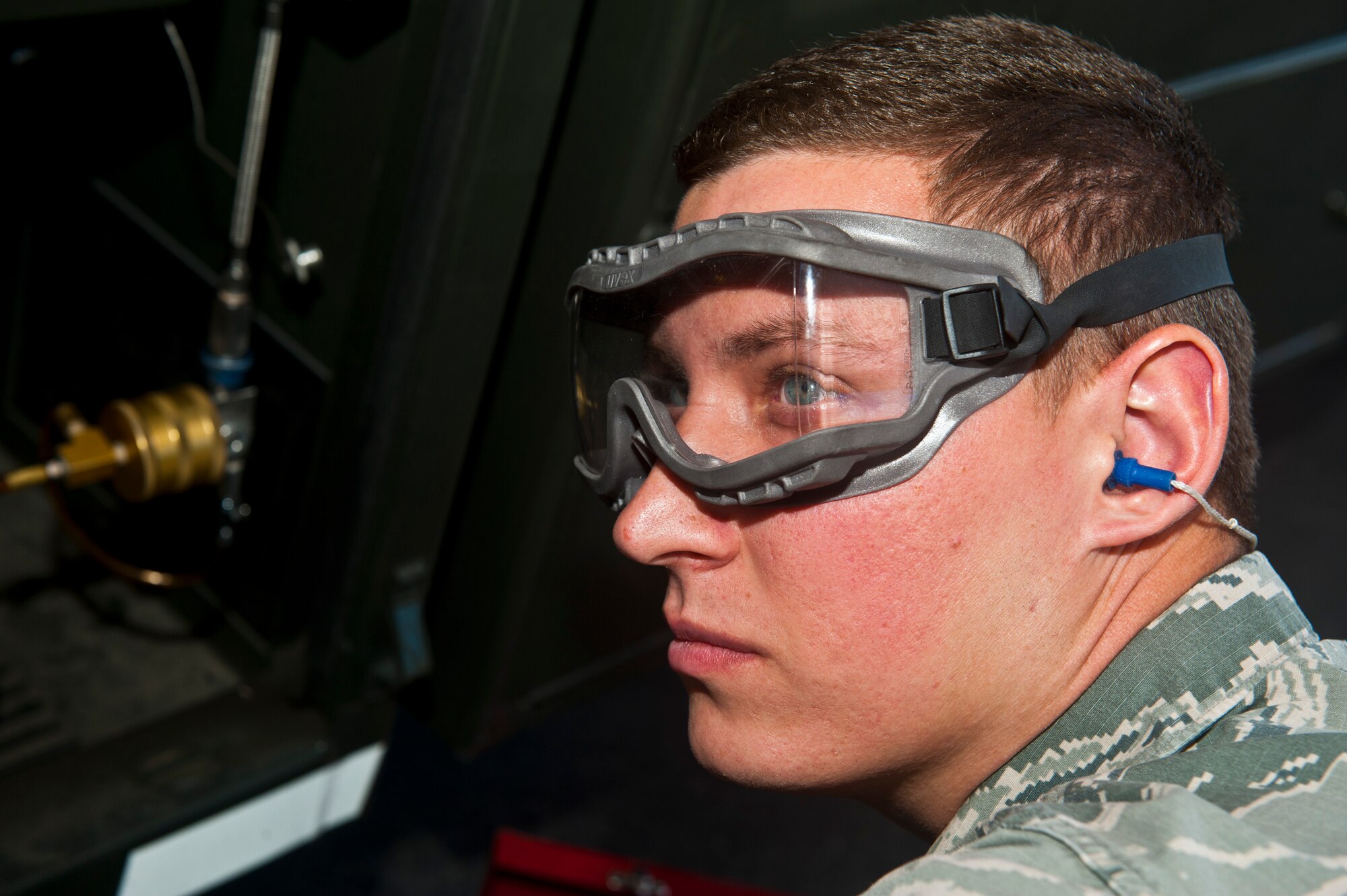 Airman 1st Class Nickolauss Guier, 99th Logistics Readiness Squadron fuel lab technician, observes fuel gauges on an R-11 fuel truck in the fuels management building Nov. 1, 2013, at Nellis Air Force Base, Nev. Guier was collecting a fuel sample to test the water and fine sediment later inside the fuel lab. (U.S. Air Force photo/Senior Airman Brett Clashman)