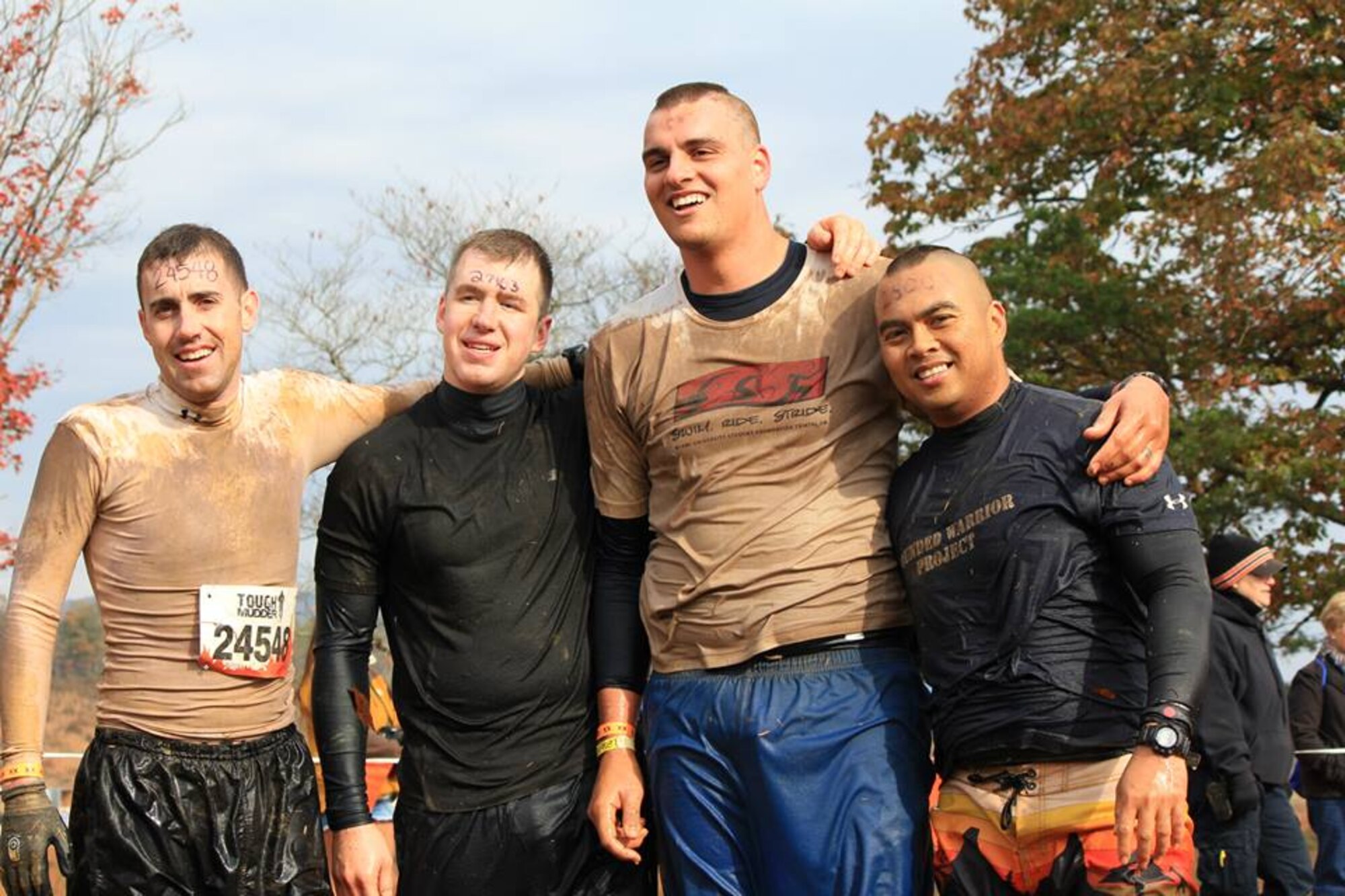 From left, U.S. Army Capt. Michael McCrory, Initial Military Training Center of Excellence aide-de-camp for the deputy commanding general, U.S. Air Force Senior Airmen Brian, 45th Intelligence Squadron, James, 30th Intelligence Squadron, and Tech. Sgt. Roy, 30th Intelligence Squadron, pose after completing the Tough Mudder event at the Peacemaker National Training Center in Gerrardstown, W.Va., Oct. 20, 2013. The team formed to take on the challenge of 25 obstacles in the West Virginia mountains and completed the challenge in three-and-a-half hours. (Courtesy photo/Released)(Some last names withheld for operational security purposes)