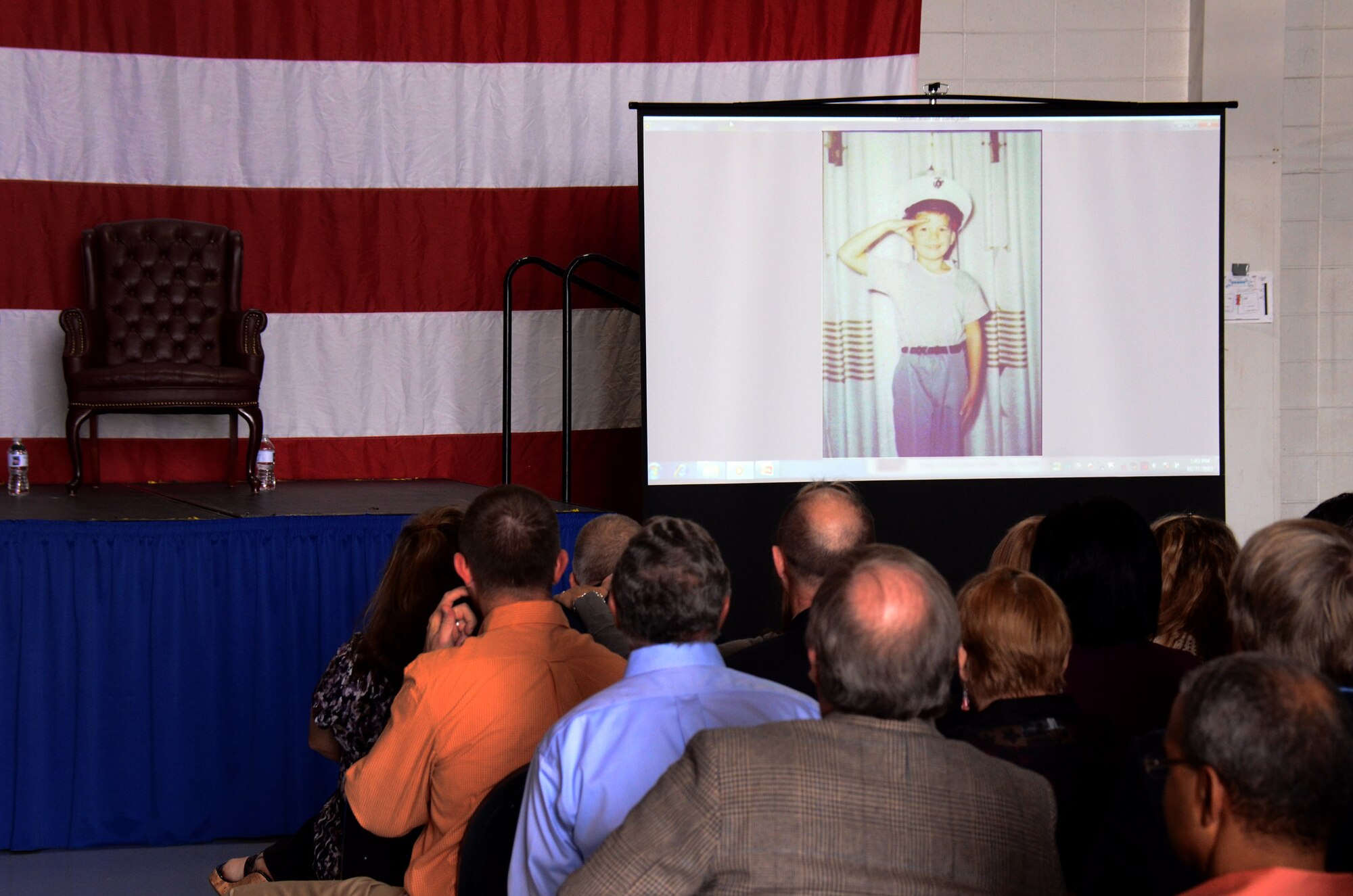 Guests view a multimedia presentation of 94th Airlift Wing  Commander Col. Tim Tarchick’s life and 35 ½ year Air Force career during his retirement ceremony Oct 31 at Dobbins Air Reserve Base, Ga. (U.S. Air Force photo/ Brad Fallin)