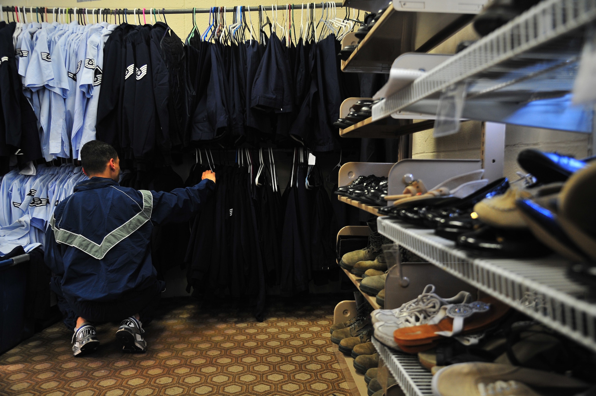U.S. Air Force Airman 1st Class Dominic Williams, 4th Equipment Maintenance Squadron precision-guided munitions crew member, searches for a light-weight blues jacket in the Airman’s Attic at Seymour Johnson Air Force Base, N.C., Oct. 31, 2013. The attic relies on volunteers and donations to help fulfill the shopping-needs of Airmen, E-1 through E-6, and their dependents. (U.S. Air Force photo by Senior Airman Aubrey White)