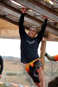 U.S. Air Force Tech. Sgt. Roy, 30th Intelligence Squadron, tackles the “Funky Monkey” horizontal ladder portion of the Tough Mudder challenge at the Peacemaker National Training Center in Gerrardstown, W.Va., Oct. 20, 2013. Roy was a part of a Joint Base Langley-Eustis team who worked on various “Crossfit” exercises and distance running to prepare for the event. (Courtesy photo/Released)(Last name withheld for operational security purposes)