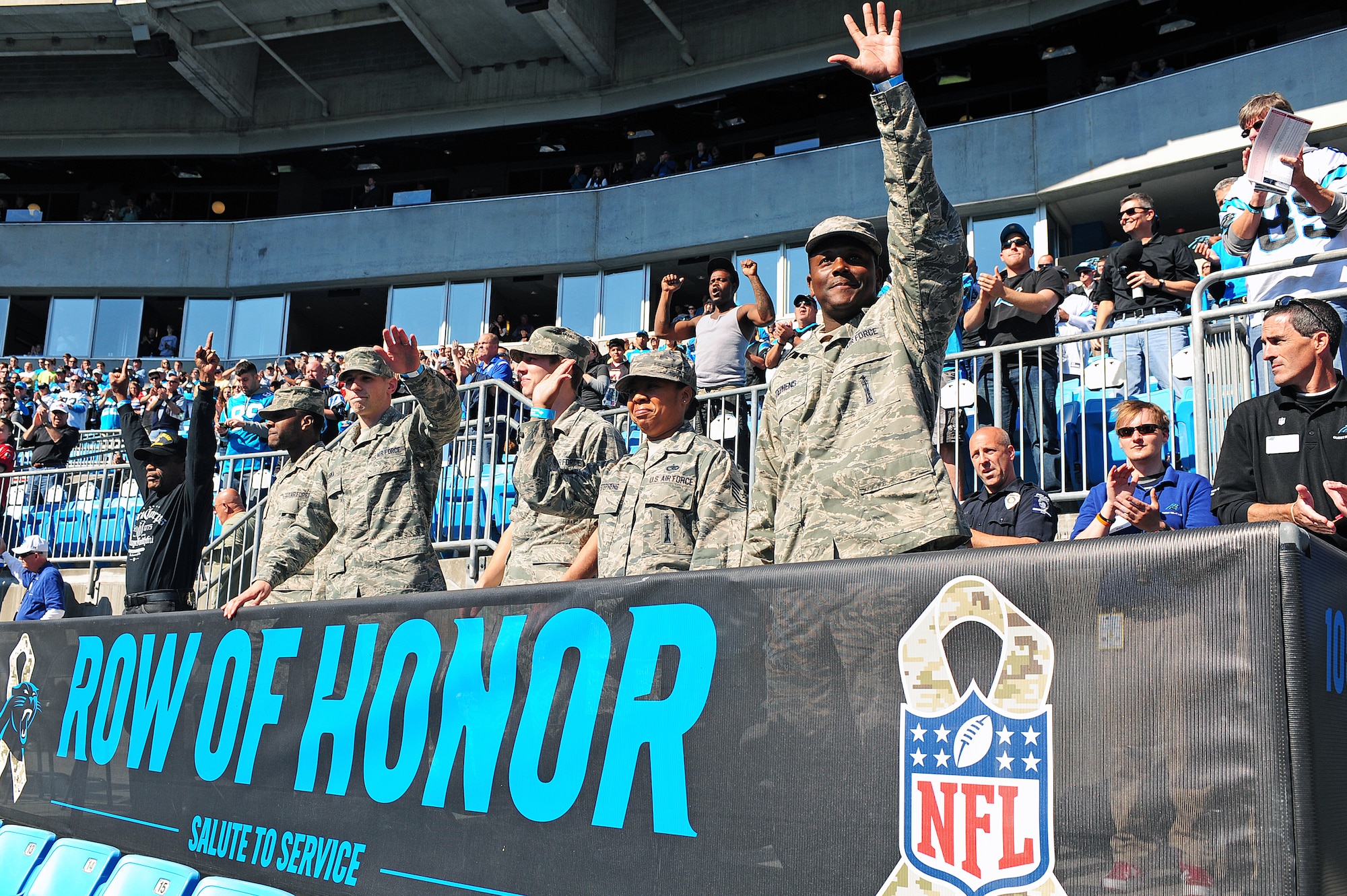Service members, past and present, wave as they are announced prior to the start of a Carolina Panthers game at Bank of America Stadium in Charlotte, N.C., Nov. 3, 2013. The National Football League paid tribute to military members by offering them free seats to the football game. (U.S. Air Force photo by Airman 1st Class John Nieves Camacho)