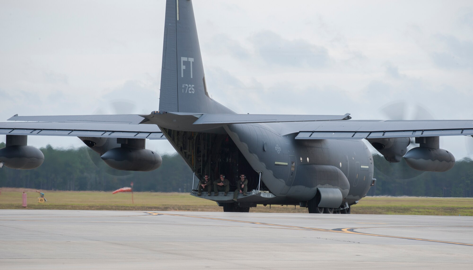 Airmen sit on the ramp of an HC-130J Combat King II at Moody Air Force Base, Ga., Nov. 1, 2013. Maintainers have logged 5,012 hours of training since July when the aircraft was first delivered to Moody. (U.S. Air Force photo by Airman 1st Class Alexis Grotz/Released)