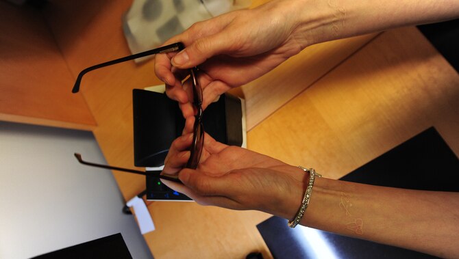 Alyssa White, 509th Medical Operations Squadron optometry technician, uses a frame warmer to adjust the size of a pair of plastic frames in the optometry clinic at Whiteman Air Force Base, Mo., Sept. 4, 2013. The frame warmer assists in making proper adjustments without breaking the frame. (U.S. Air Force photo by Staff Sgt. Nick Wilson/Released)