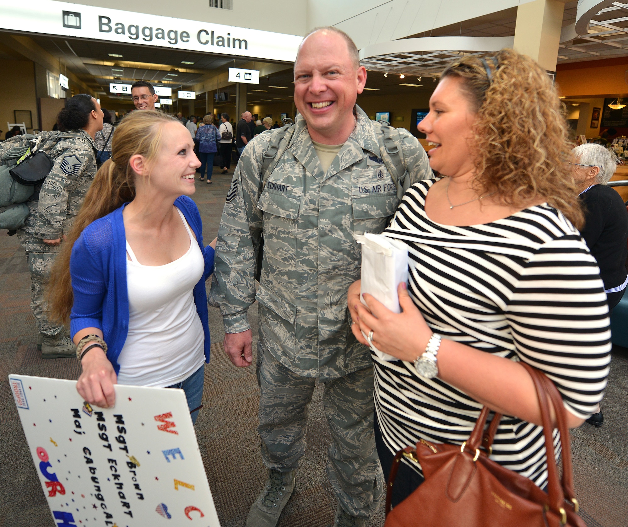 WRIGHT-PATTERSON AIR FORCE BASE, Ohio – Master Sgt. Brad Eckhart, 445th Aeromedical Evacuation Squadron, operations support flight superintendent, celebrates with family and friends at the Dayton International Airport after returning home from a six-month deployment Sept. 26, 2013. Eckhart and two other AES reservists returning home the same day were part of medical evacuation teams flying patients from downrange, to Germany and the United States. (U.S. Air Force photo/Tech. Sgt. Frank Oliver)
