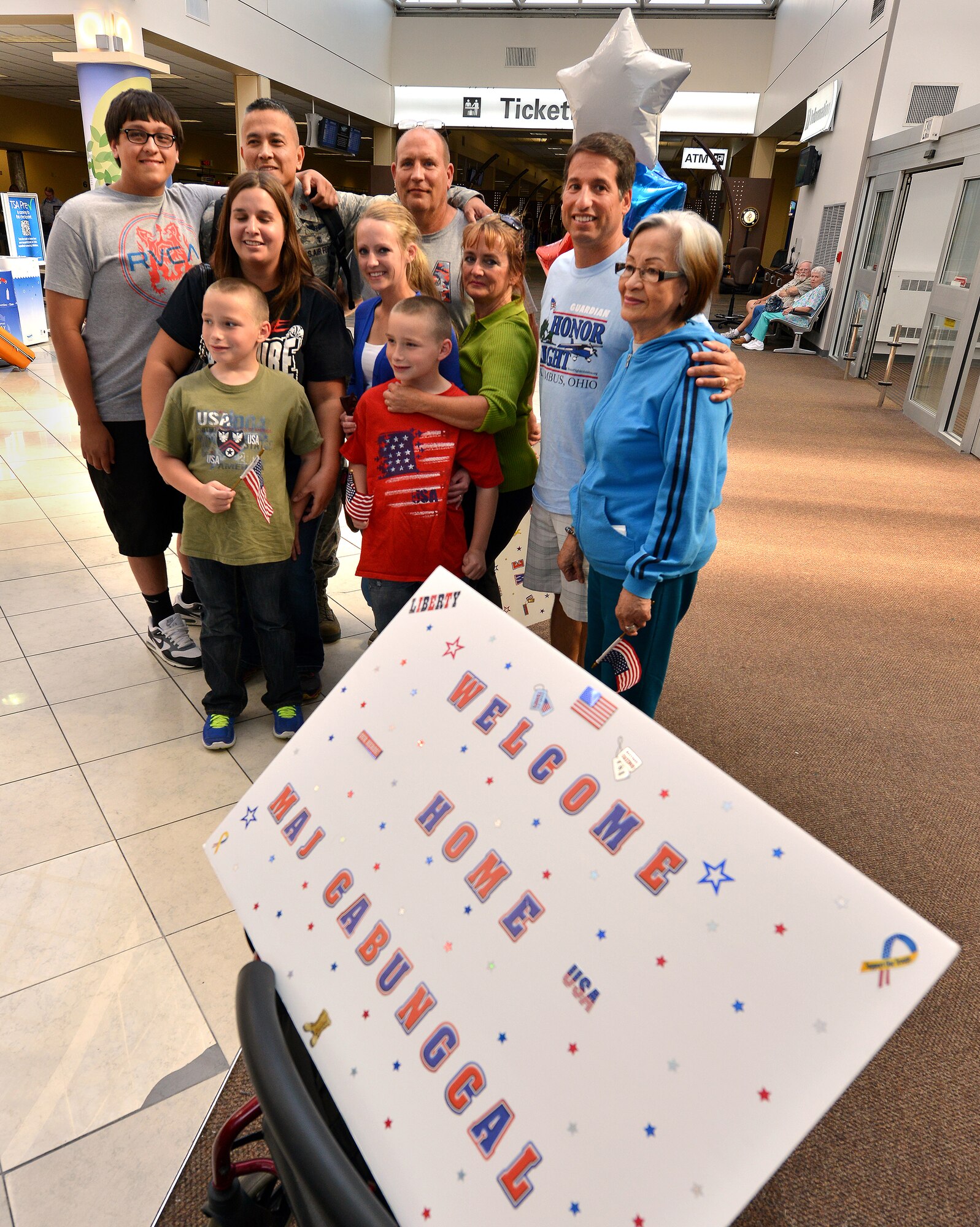 WRIGHT-PATTERSON AIR FORCE BASE, Ohio – Maj. Romeo Cabungcal, 445th Aeromedical Evacuation Squadron, flight nurse, celebrates with family and friends at the Dayton International Airport after returning home from a six-month deployment Sept. 26, 2013. Eckhart and two other AES reservists returning home the same day were part of medical evacuation teams flying patients from downrange, to Germany and the United States. (U.S. Air Force photo/Tech. Sgt. Frank Oliver)