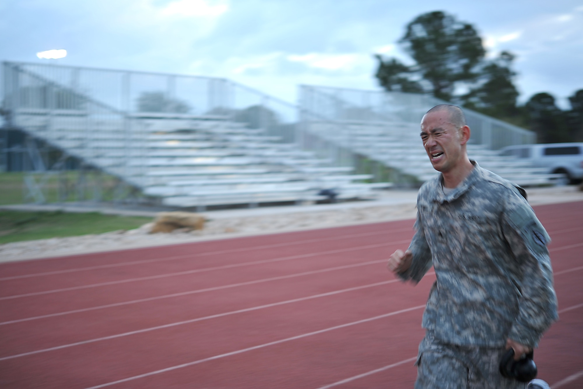 GOODFELLOW AIR FORCE BASE, Texas-- Army Sgt. Sanghyuk Yim, 344th Military Intelligence Battalion student, runs with a kettle bell during the Iron Soldier Competition Oct. 26. The final event of the competition was a 1600 meter relay with a 10 pound kettle bell “baton”. (U.S. Air Force photo/ Senior Airman Michael Smith)