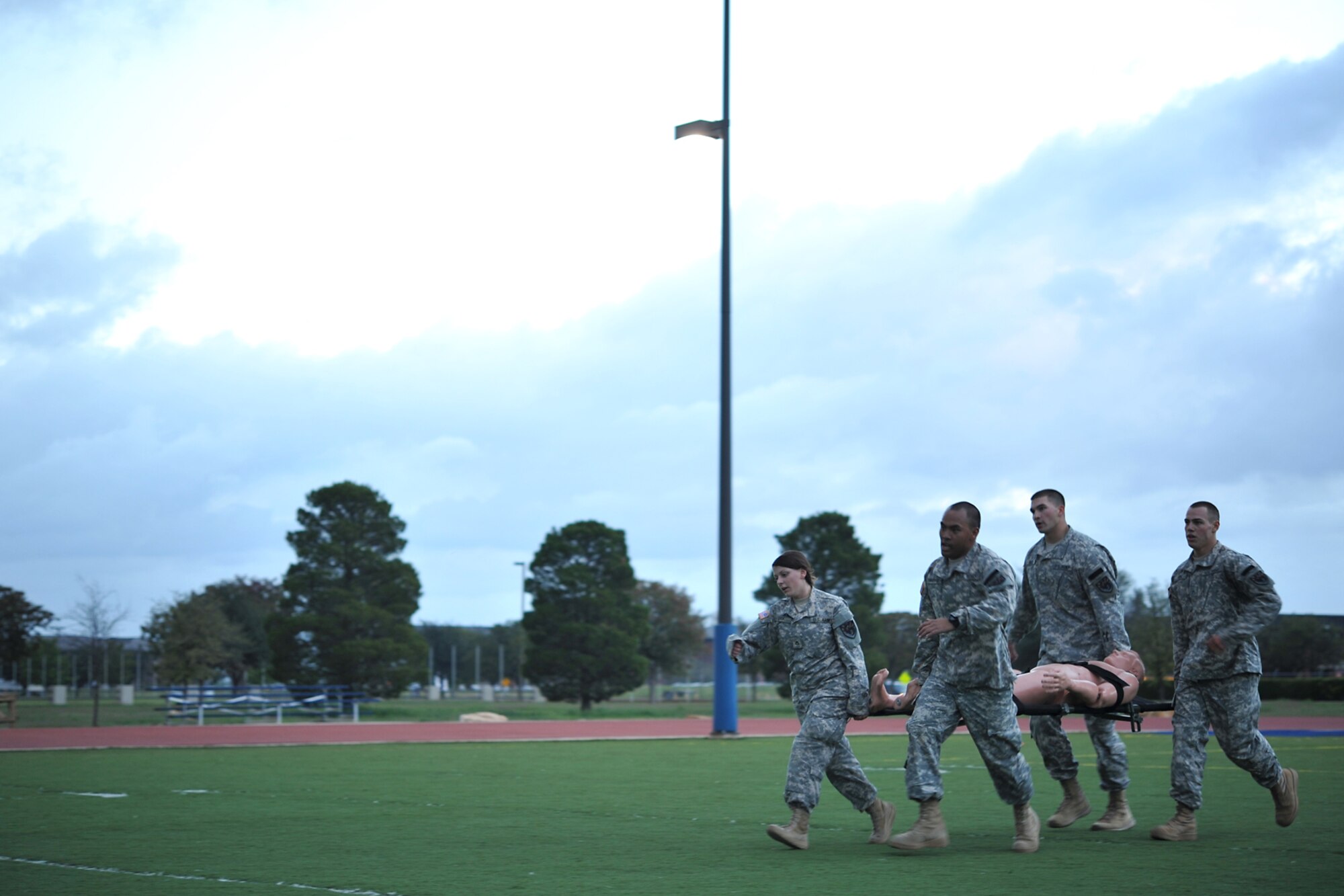 GOODFELLOW AIR FORCE BASE, Texas-- Soldiers from the Army 344th Military Intelligence Battalion carry a litter while participating in the Iron Soldier Competition Oct. 26. The competition is made up of teams of four soldiers who race against time to complete grueling physical and mental tasks. (U.S. Air Force photo/ Senior Airman Michael Smith)