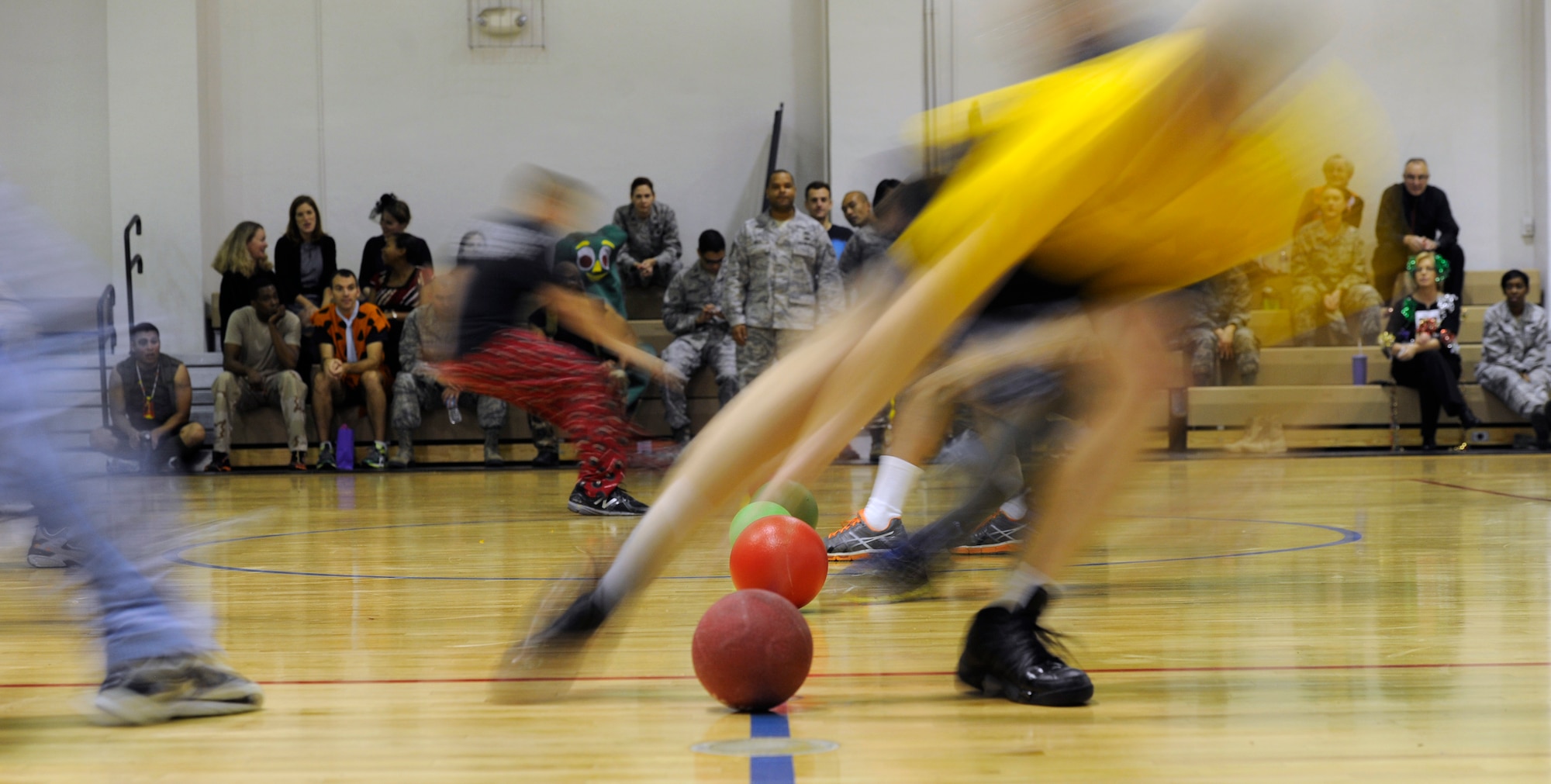 Wingman Costume Dodge Ball participants grab ammunition at the East Fitness Center on Joint Base Andrews, Md., Oct. 31 2013. Air Force Legal Operations Agency hosted the tournament to boost morale.  The event was comprised of six teams, a prize raffle and Halloween inspired treats. (U.S. Air Force photo/ Airman 1st Class Nesha Humes)