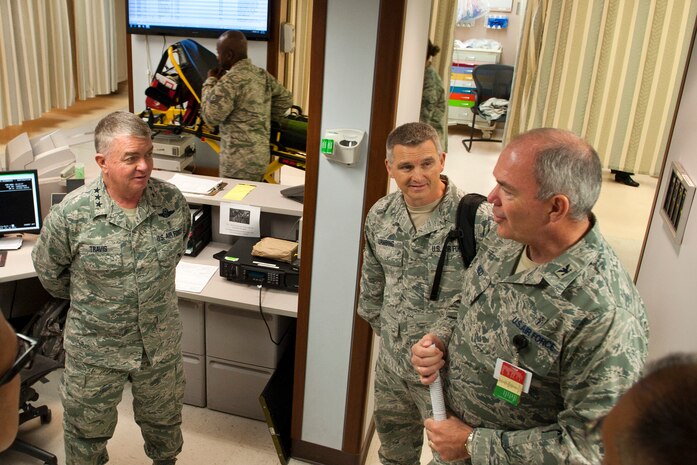 U.S. Air Force Surgeon General Lt. Gen. (Dr.) Thomas Travis, , and Chief Master Sgt. Kevin Lambing (middle), USAF Surgeon General’s Enlisted Corps chief, receive a briefing from Col. (Dr.) Howard Reid, 99th Medical Operations Squadron commander, on the Mike O’Callaghan Federal Medical Center’s emergency room procedures, Oct. 30, 2013, at Nellis Air Force Base, Nev. Travis was visiting Nellis AFB to observe the progress and evolving capabilities of the MOFMC and to build strategic partnerships with local medical services in the Las Vegas. The surgeon general’s office advises the Secretary of the Air Force and Air Force Chief of Staff, as well as the Assistant Secretary of Defense for Health Affairs, on matters pertaining to the medical aspects of the Air and Space Expeditionary Force and the health and medical readiness of Airmen. (U.S. Air Force photo by Airman 1st Class Thomas Spangler) 
