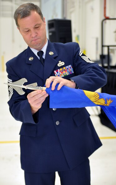 YOUNGSTOWN AIR RESERVE STATION, Ohio—U.S. Air Force Reserve Senior Master Sgt. Ray Kuneli, the 910th Maintenance Operations Flight (MOF) superintendent, prepares the organization’s flag to be put in a case, here, Nov. 2, 2013. Kuneli encased the flag during a ceremony to deactivate the MOF. (U.S. Air Force photo by Tech. Sgt. Valerie Smock)