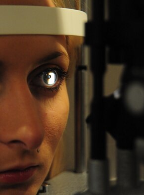 A slit lamp is used to evaluate the eyes of Alyssa White, 509th Medical Operations Squadron optometry technician, in the optometry clinic at Whiteman Air Force Base, Mo., Sept. 4, 2013. The slit lamp is also used to help check for proper fit of contact lenses on patients’ eyes.  (U.S. Air Force photo by Staff Sgt. Nick Wilson/Released)