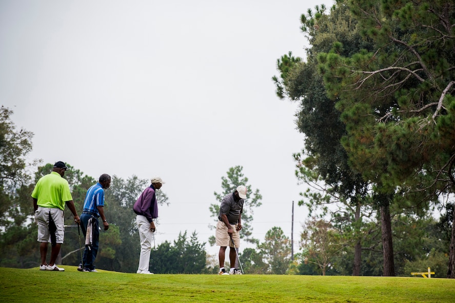 A team of golfers prepares to hit their putt shots during the 2013 Retiree Appreciation Week Golf Tournament at Moody Air Force Base, Ga., Nov. 1, 2013. Twelve teams of four competed in the annual tournament that has been one of the main draws during Retiree Appreciation Week throughout the years. (U.S. Air Force photo by Staff Sgt. Jamal D. Sutter/Released)