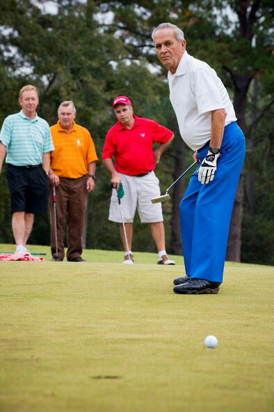 Retired U.S. Air Force Chief Master Sgt. Bill Usic watches his golf ball after putting during the 2013 Retiree Appreciation Week Golf Tournament at Moody Air Force Base, Ga., Nov. 1, 2013. During Retiree Appreciation Week, retirees from all branches of service are welcomed to come out and take part in many events, discounts and information briefs at their disposal. (U.S. Air Force photo by Staff Sgt. Jamal D. Sutter/Released) 
