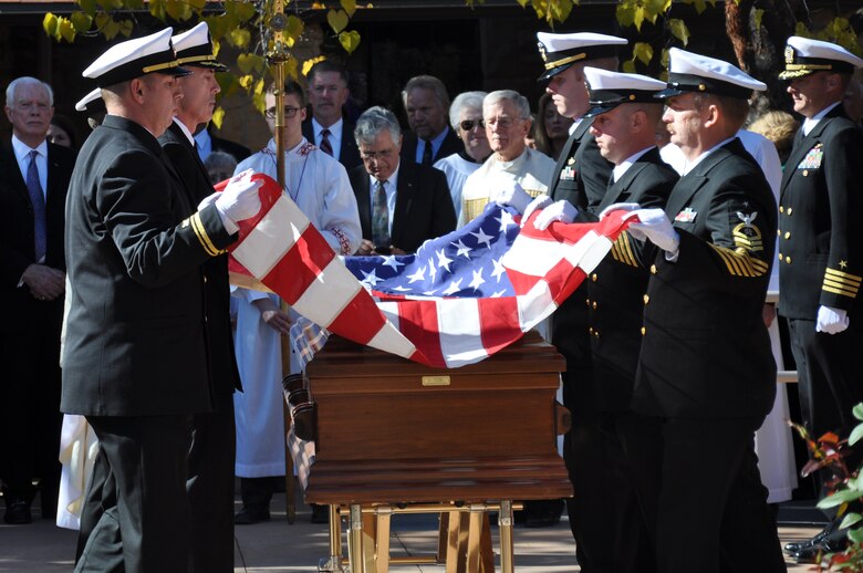 Pall bearers fold an American flag during the military honors ceremony for retired Cmdr. Scott Carpenter’s funeral Nov. 2, 2013, at St. John Episcopal Church in Boulder, Colo. Carpenter was the first human ever to hold the title of astronaut and aquanaut. He was the fourth American astronaut to fly in space and the second to orbit the Earth. (U.S. Air Force photo by Staff Sgt. Lucas Morrow/Released)