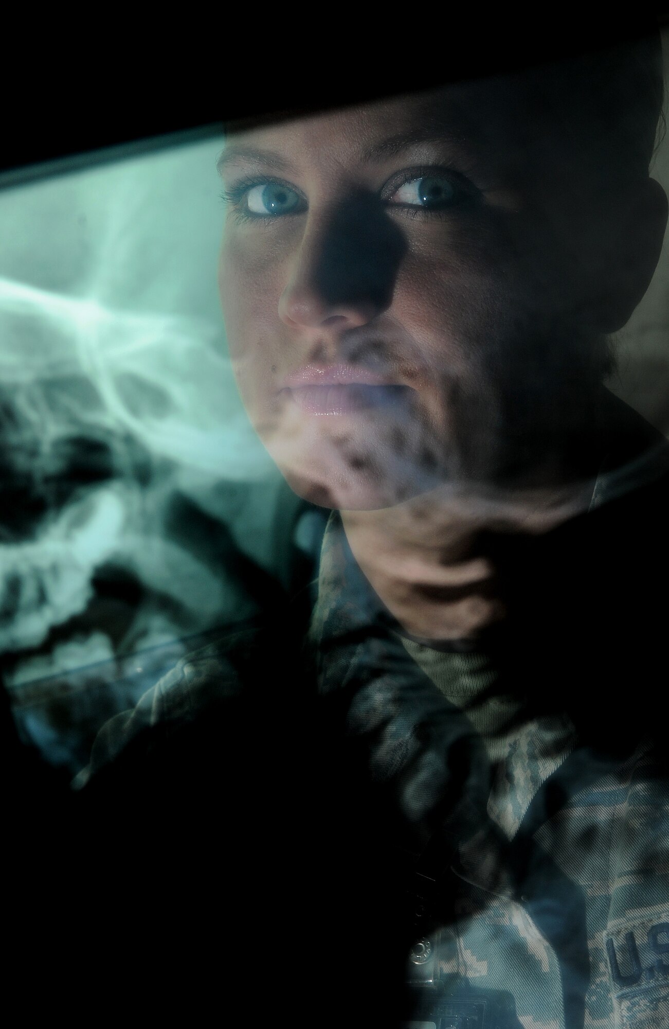 Staff Sgt Carla Hisghman, 5th Medical Support Squadron radiology technologist, views an x-ray of a human skull at Minot Air Force Base, N.D., Oct. 29, 2013. X-rays are a form of radiograph which shows the organs and bones of the human body superimposed over each other with bones appearing whiter and more solid than soft tissues. (U.S. Air Force photo/Senior Airman Stephanie Sauberan)