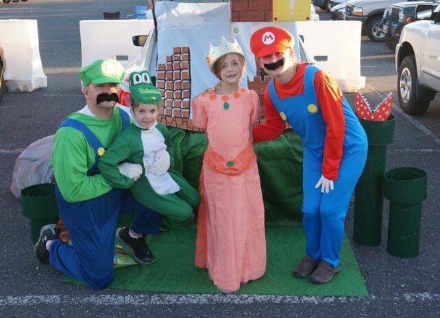 The Harris family dressed as characters from the Mario Brothers to hand out treats at the trunk or treat activity at the Haunting the Hill event on Oct. 25. (Sarah Stoll/Hilltop Times correspondent)