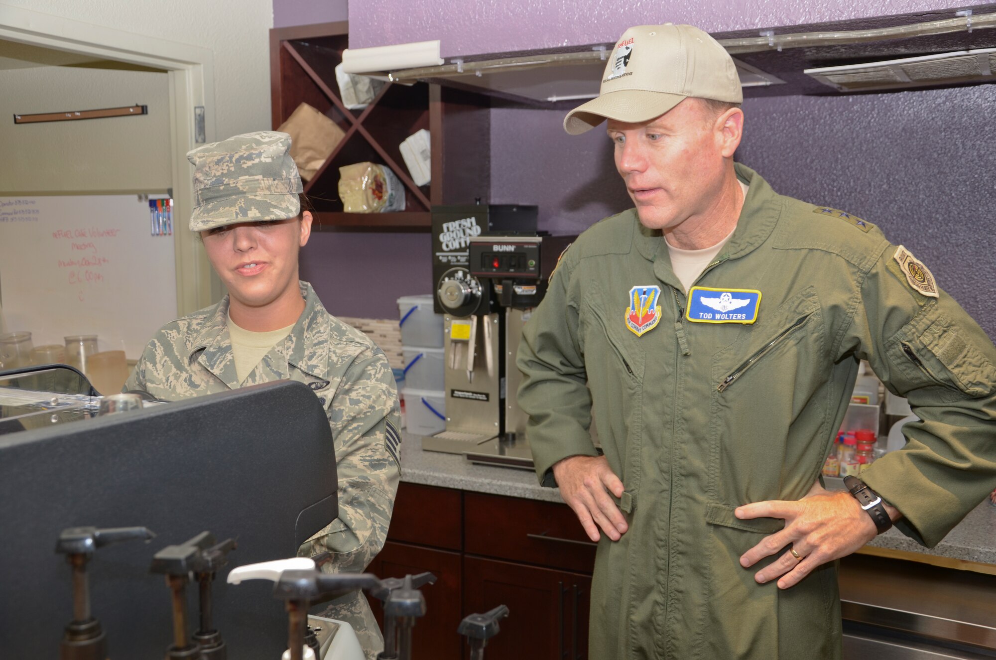 Staff Sgt. Holly Lodin, 49th Wing chaplain assistant, demonstrates how the Airmen at the Refuel Café prepare gourmet coffee to Lt. Gen. Tod Wolters, 12th Air Force (Air Forces Southern) commander during a tour of Holloman Air Force Base, N.M., Oct. 24. Holloman was the first base Gen. Wolters visited after assuming command at Davis-Monthan AFB, Ariz., Sept. 24. The 12th Air Force is responsible for the combat readiness of 10 active duty wings, operating more than 800 aircraft with more than 64,500 uniformed and civilian Airmen. (U.S. Air Force photo by Staff Sgt. Warren Spearman/Released)

