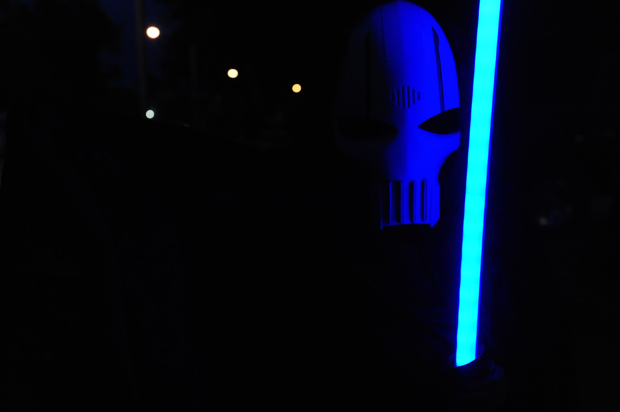 A child holds a light saber while going trick-or-treating at Seymour Johnson Air Force Base, N.C., Oct. 31, 2013.  Hundreds of costumed children walked the streets of base housing in hopes of increasing their candy stashes.  (U.S. Air Force photo by Airman 1st Class Brittain Crolley)