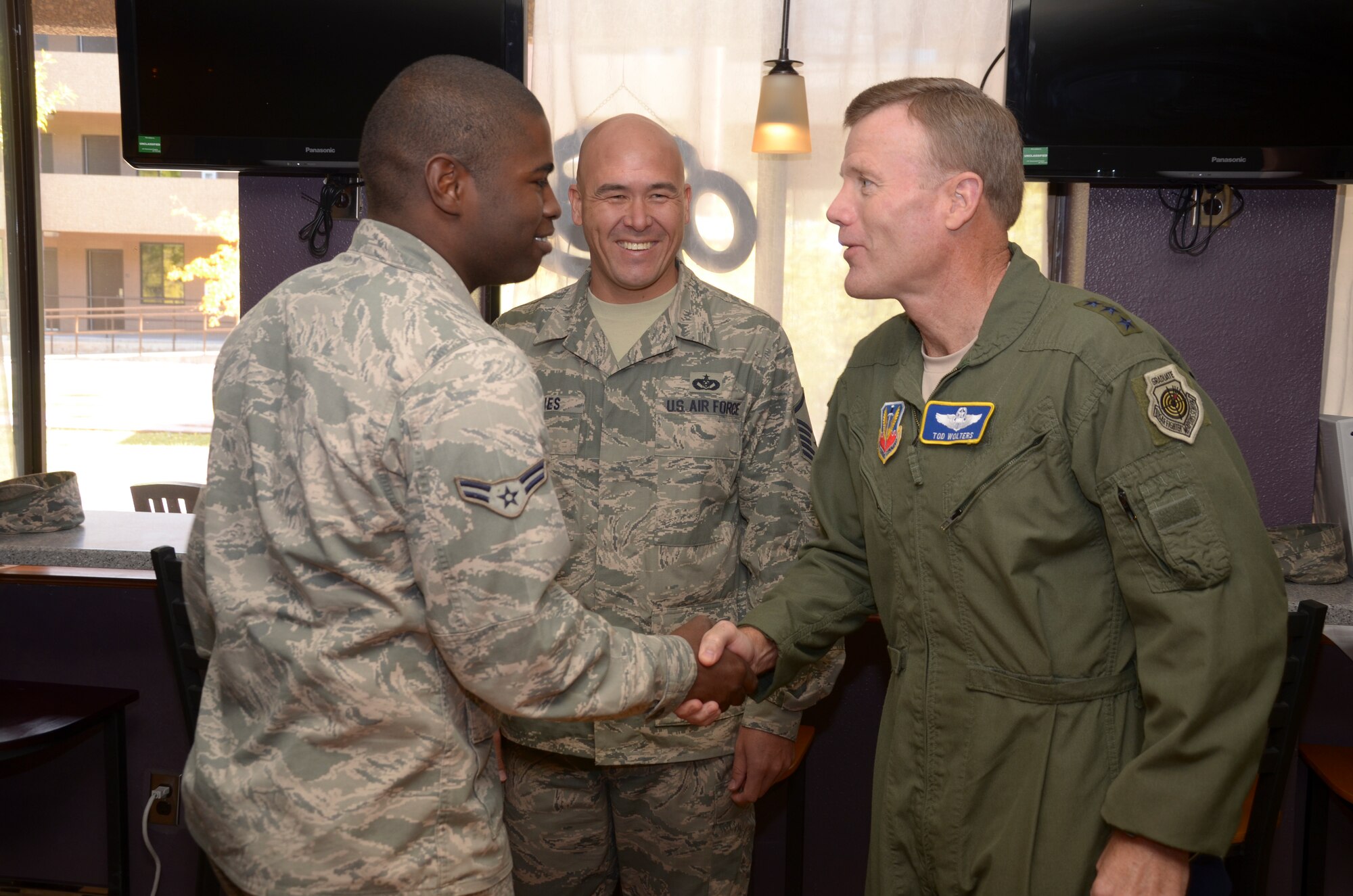 Airman 1st Class Jermar Gates, 49th Maintenance Group and Refuel Café volunteer, greets Lt. Gen. Tod Wolters, 12th Air Force (Air Forces Southern) commander during a tour of Holloman Air Force Base, N.M., Oct. 24. Holloman was the first base Gen. Wolters visited after assuming command at Davis-Monthan AFB, Ariz., Sept. 24. The 12th Air Force is responsible for the combat readiness of 10 active duty wings, operating more than 800 aircraft with more than 64,500 uniformed and civilian Airmen. (U.S. Air Force photo by Staff Sgt. Warren Spearman/Released)