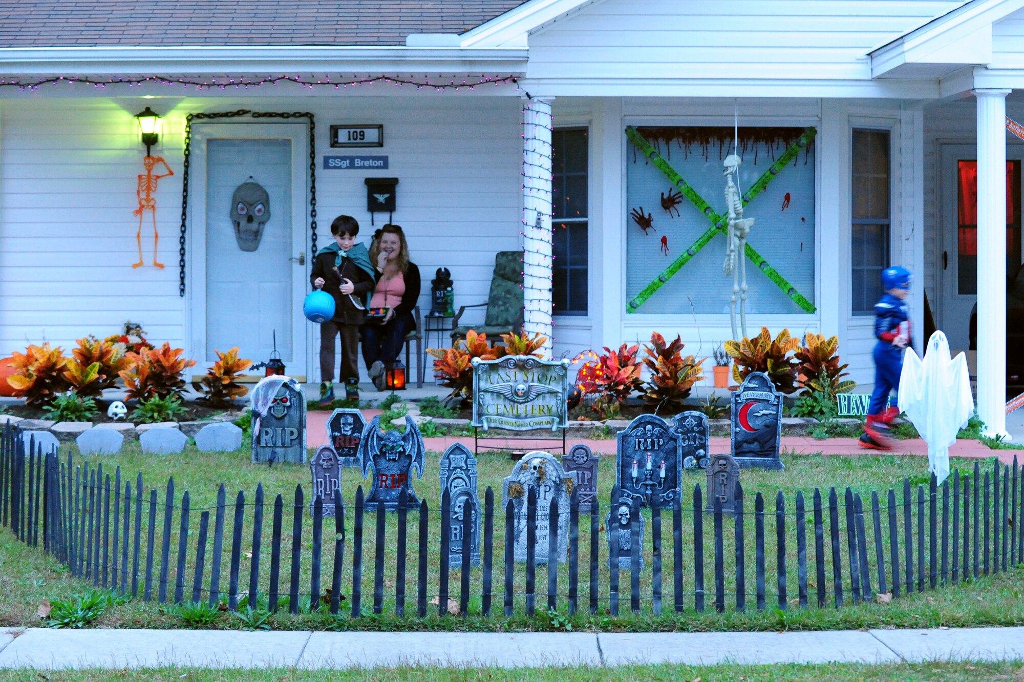 Children visit the house of U.S. Air Force Staff Sgt. Andrew Breton, 4th Aircraft Maintenance Squadron assistant NCO in charge of the end-of-runway inspection team, during trick-or-treating at Seymour Johnson Air Force Base, N.C., Oct. 31, 2013.  Breton’s decorations featured a haunted graveyard for children to pass by on their way to get candy.  (U.S. Air Force photo by Airman 1st Class Brittain Crolley)