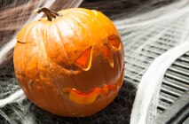 A pumpkin sits on the tailgate of a truck at the Trunk or Treat event, Oct. 31. The event, hosted by 5th Logistics Readiness Squadron Vehicle Operations and Balfour Beatty Communities, featured treats, an inflatable castle and a haunted house for base residents. (U.S. Air Force photo/Airman 1st Class Apryl Hall)