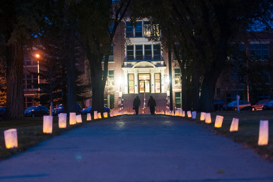 Minot residents walk down the candlelit path to the Take Back the Night event held at Minot State University’s McFarland Lobby, Oct. 29. The event, meant to raise awareness on domestic violence and sexual harassment, featured informational booths, guest speakers, live music and a vigil walk. (U.S. Air Force photo/Airman 1st Class Apryl Hall)