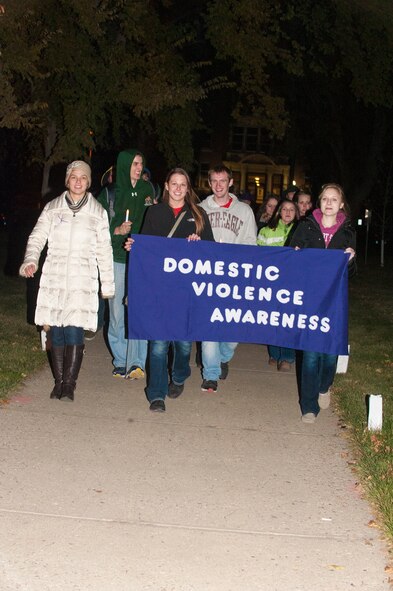 Minot State University students lead the way during a vigil walk at the Take Back the Night event, Oct. 29. Students, local members of the community and Minot Air Force Base residents gathered at the event to help raise awareness on domestic violence and sexual harassment. (U.S. Air Force photo/Airman 1st Class Apryl Hall)