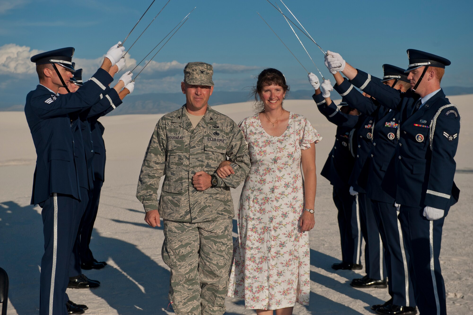 Colonel Robert Letourneau, 49th Wing Material Maintenance Group commander, and his wife, Pam Letourneau, walk under the cordon for a vow renewal ceremony at White Sands National Monument, N.M., Oct. 25. Holloman Air Force Base hosted the ceremony, followed by a reception at the Desert Sands Enlisted Club as a part of National Domestic Violence awareness month. (U.S. Air Force photo by Airman 1st Class Aaron Montoya/Released)