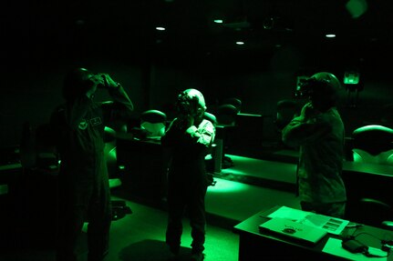 (from right to left) 1st Lt. Michael Vastola, 359th Aerospace Medicine Squadron, shows Master Sgt. Patricia Manzur Ballard, and Capt. Danny Elich, 359th Aerospace Medicine Squadron, Aviano Air Force Base, Italy, practice aligning night vision goggles Oc. 28 at Joint Base San Antonio-Randolph. (U.S. Air Force photo by Rich McFadden)
