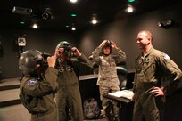 (from right to left) 1st Lt. Michael Vastola, 359th Aerospace Medicine Squadron, shows Master Sgt. Patricia Manzur Ballard, and Capt. Danny Elich, 359th Aerospace Medicine Squadron, Aviano Air Force Base, Italy, practice aligning night vision goggles Oc. 28 at Joint Base San Antonio-Randolph. (U.S. Air Force photo by Rich McFadden)