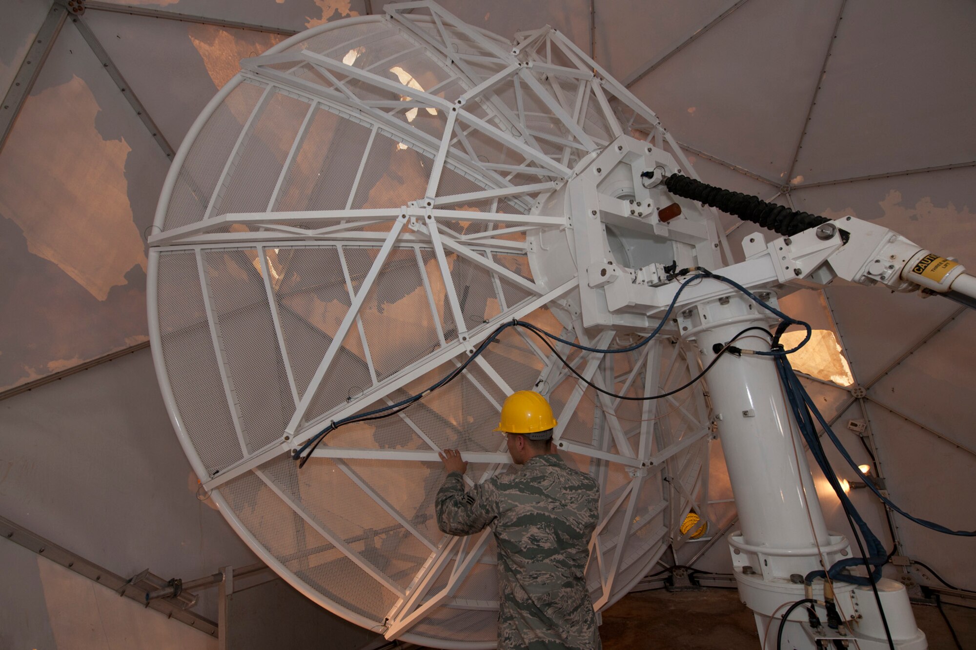 U.S. Air Force Senior Airman Frederick Rosario, 65th Communications Squadron radio frequency transmission technician, guides a MARK IVB Weather System into position to perform an 84-day preventive maintenance inspection Oct. 31, 2013, at Lajes Field, Azores.  The weather system provides real-time, mid-Atlantic weather imagery and services to more than 2,000 users at more than 250 locations. (U.S. Air Force photo by Tech. Sgt. Paul Villanueva II/Released)