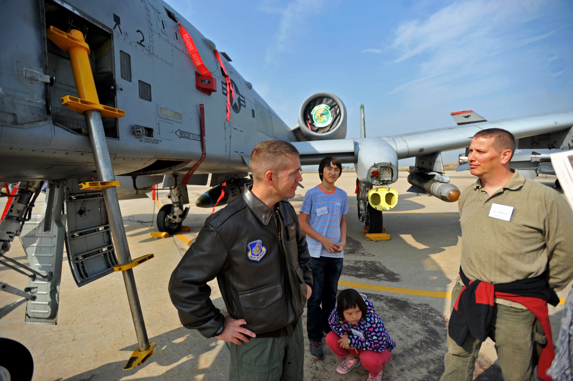 Capt. Aaron Bigler, 25th Fighter Squadron A-10 Thunderbolt pilot, speaks to a U.S. and Republic of Korea Family Day participant at Osan Air Base, ROK, Nov. 1, 2013. The family day was held to strengthen the bond between ROK and U.S. forces, and give participants a closer look at the base’s daily operations. (U.S. Air Force photo/Senior Airman Siuta B. Ika)