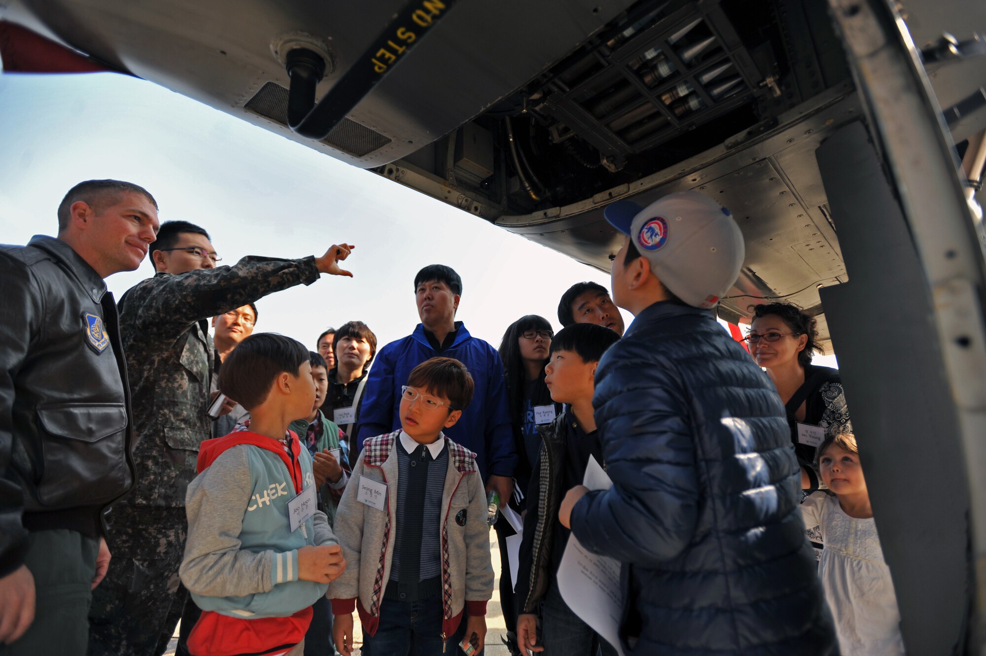 U.S. and Republic of Korea Family Day participants look at the underside of an A-10 Thunderbolt at Osan Air Base, ROK, Nov. 1, 2013. During the event, A-10 and F-16 Fighting Falcon pilots briefed audiences about their aircrafts’ capabilities and what it’s like to be a fighter pilot. (U.S. Air Force photo/Senior Airman Siuta B. Ika)