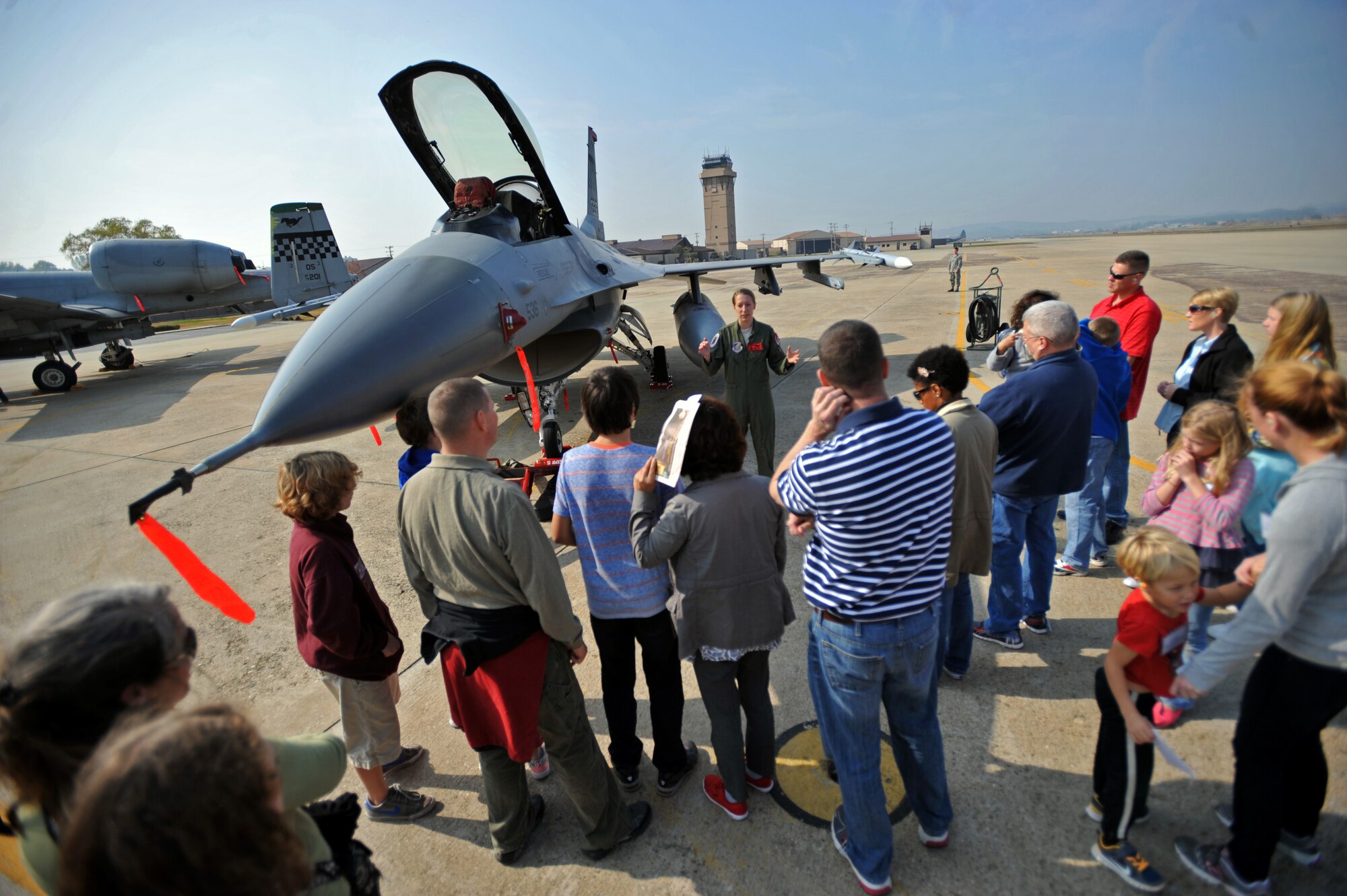 First Lt. Clancy Morrical, 36th Fighter Squadron F-16 Fighting Falcon pilot, speaks to participants of a U.S. and Republic of Korea  Family Day at Osan Air Base, ROK, Nov. 1, 2013. The event was open to active duty members and dependents to strengthen the bond between both Air Forces, and give attendees a closer look at the base’s daily operations. (U.S. Air Force photo/Senior Airman Siuta B. Ika)