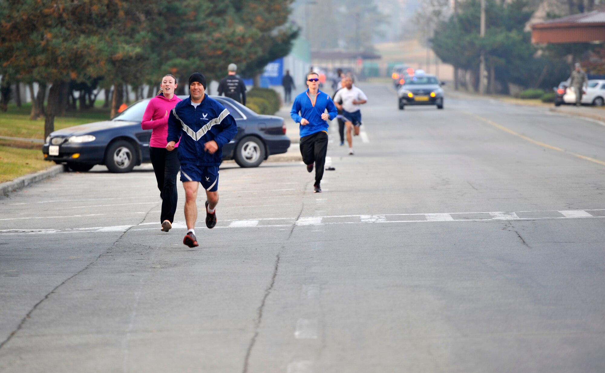 Col. Brook Leonard, 51st Fighter Wing commander, and Capt. Robyn Thome, 7th Air Force section commander, approach the finish line of the Combined Federal Campaign 5K at Osan Air Base, Republic of Korea, Nov. 1, 2013. Thome was the fastest female runner with a time of 25:25 (U.S. Air Force photo/Staff Sgt. Emerson Nuñez)