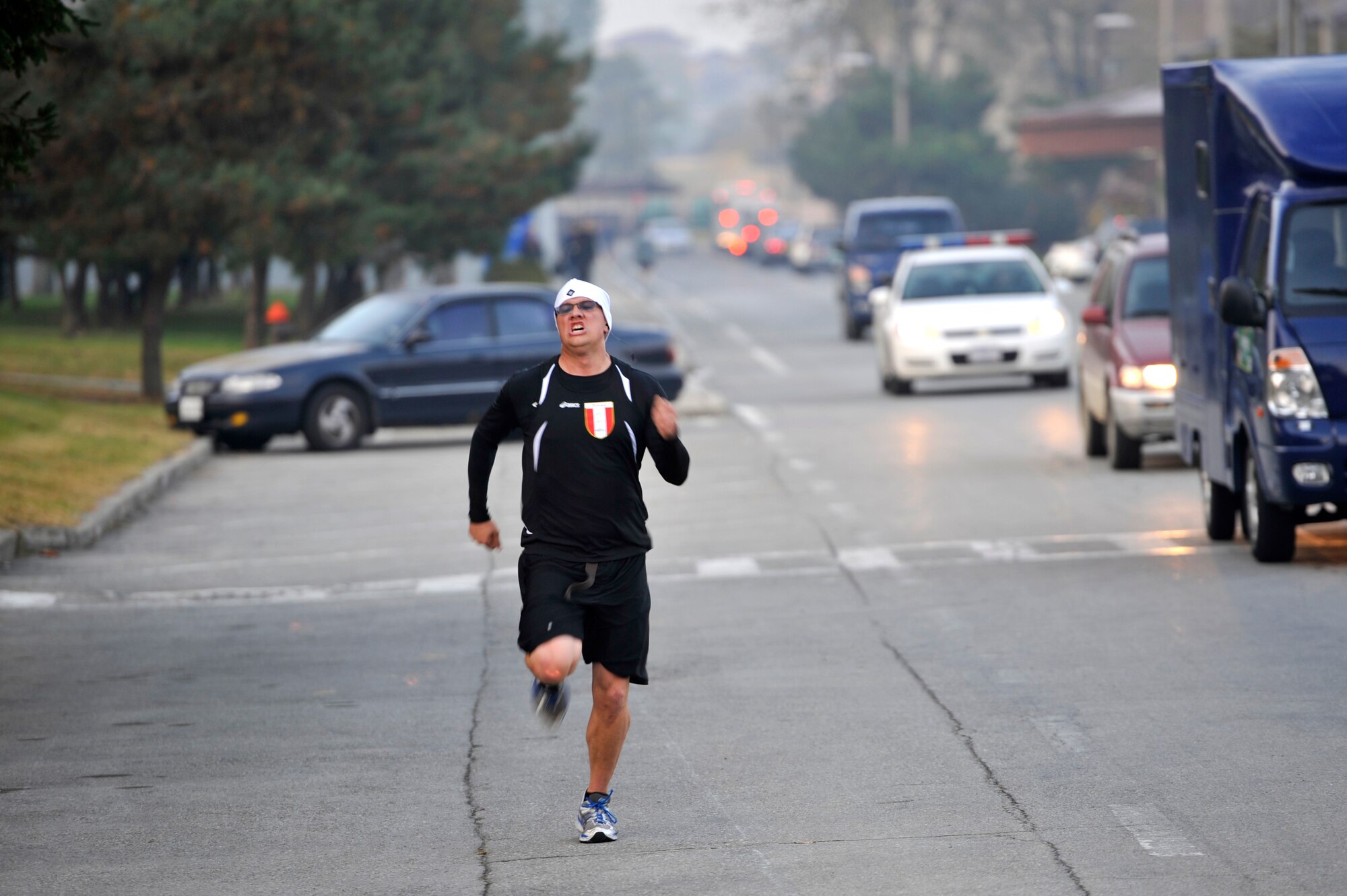 Senior Airman William Delaney, 51st Logistics Readiness Squadron mobile distribution operator, sprints toward the finish line of the Combined Federal Campaign 5K at Osan Air Base, Republic of Korea, Nov. 1, 2013. Delaney was the fastest overall runner with a time of 20:45. (U.S. Air Force photo/Staff Sgt. Emerson Nuñez)