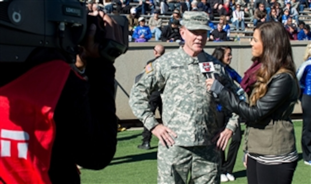 An ESPN U sideline reporter interviews Chairman of the Joint Chiefs of Staff Gen. Martin E. Dempsey during the Army versus Air Force football game at Falcon Stadium in Colorado Springs, Colo., on Nov. 02, 2013.  The Air Force Falcons beat the Army Black Knights with a score of 42-28.  