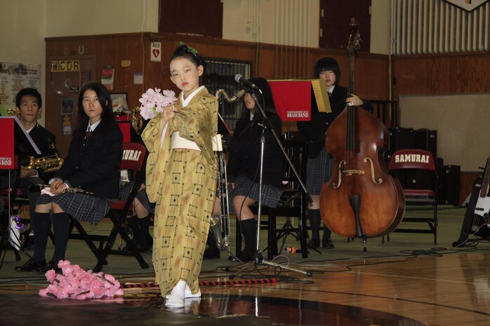 Kirara Yeda, 9, a member of the Shunan International Children’s Club, Children Dance Division, performs a Japanese dance in the gymnasium at the Mathew C. Perry Elementary School here Nov. 23. The Japanese performers came to visit as a way of saying thank you for the support the school gave during Operation Tomodachi. The festival had performers from the Shunan International Children’s Club, the Shunan Children’s Choir and the Yamaguchi Prefectural Shinnanyo High School Brass band visit M.C. Perry Elementary to continue the ongoing friendship of the station and Shunan city.