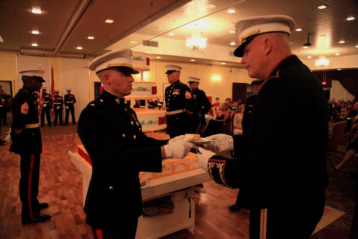 Chief Warrant Officer Bryan N. Collver, left, hands a piece of celebratory cake to Brig. Gen. Niel E. Nelson Nov. 1 during a ceremony at the Butler Officers Club on Camp Foster, Okinawa, Japan. The ceremony was held to honor the Marine Corps’ 238th birthday, which is on Nov. 10. The Marines are with 3rd Marine Logistics Group, III Marine Expeditionary Force. 
