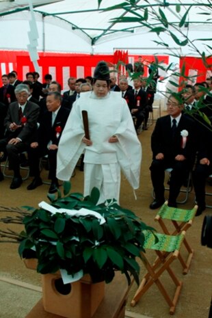 An Iwakuni City Shirasaki Shrine priest walks to her seat during the purification and blessing of the Iwakuni Kintaikyo Airport ground breaking ceremony here Nov. 25. The priests asked the Shinto God and local guardian spirits to bless and protect the construction workers as they build the new air terminal.
