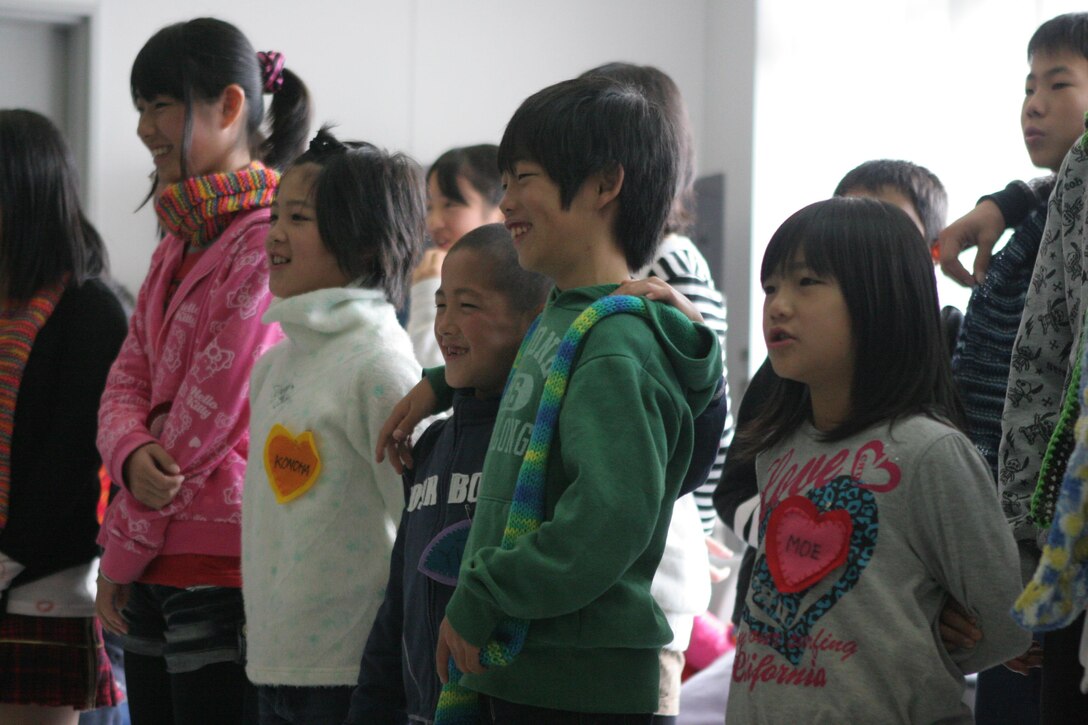 Akibono Orphanage children sing the orpahanage’s school song to show their appreciation during an on-base visit at the Robert M. Casey Medical and Dental Clinic here Saturday. The children spent the day making Christmas tree decorations, decorating cookies and singing classic Christmas songs. At the end of the event, Santa Claus came to visit the children.